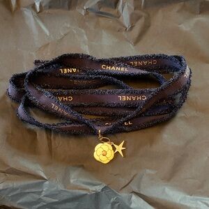 Chanel Holiday 2025 Camellia Charm with logo ribbons